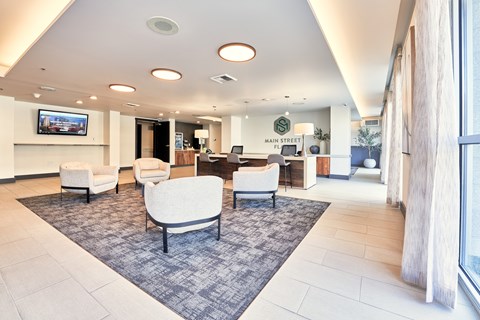 a large lobby with chairs and a rug